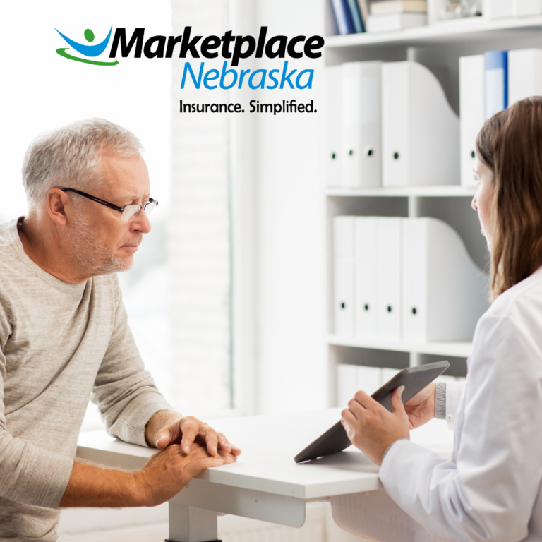 Elderly Man looking at a tablet screen presented by a doctor