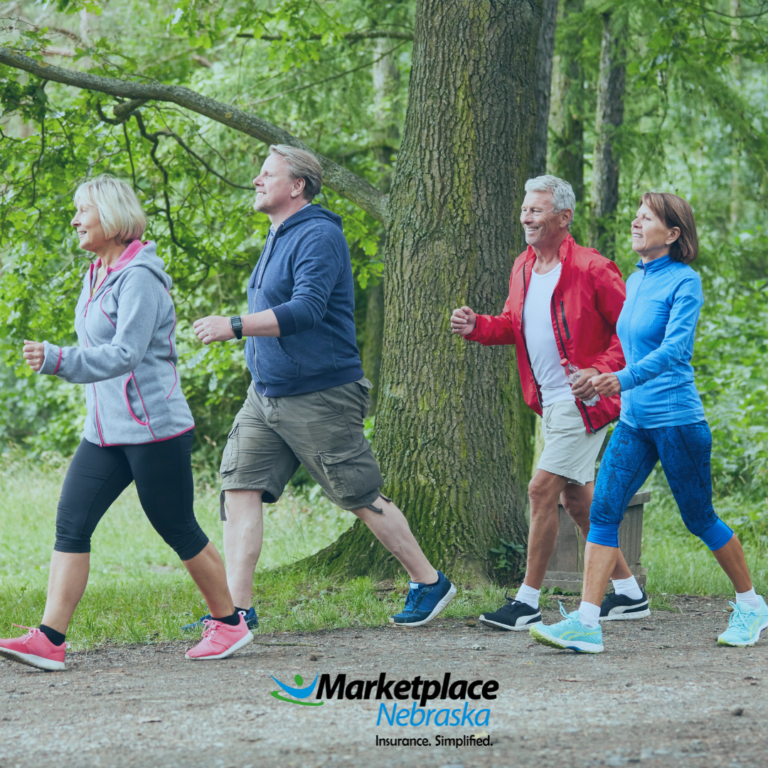 4 elderly people walking together outside